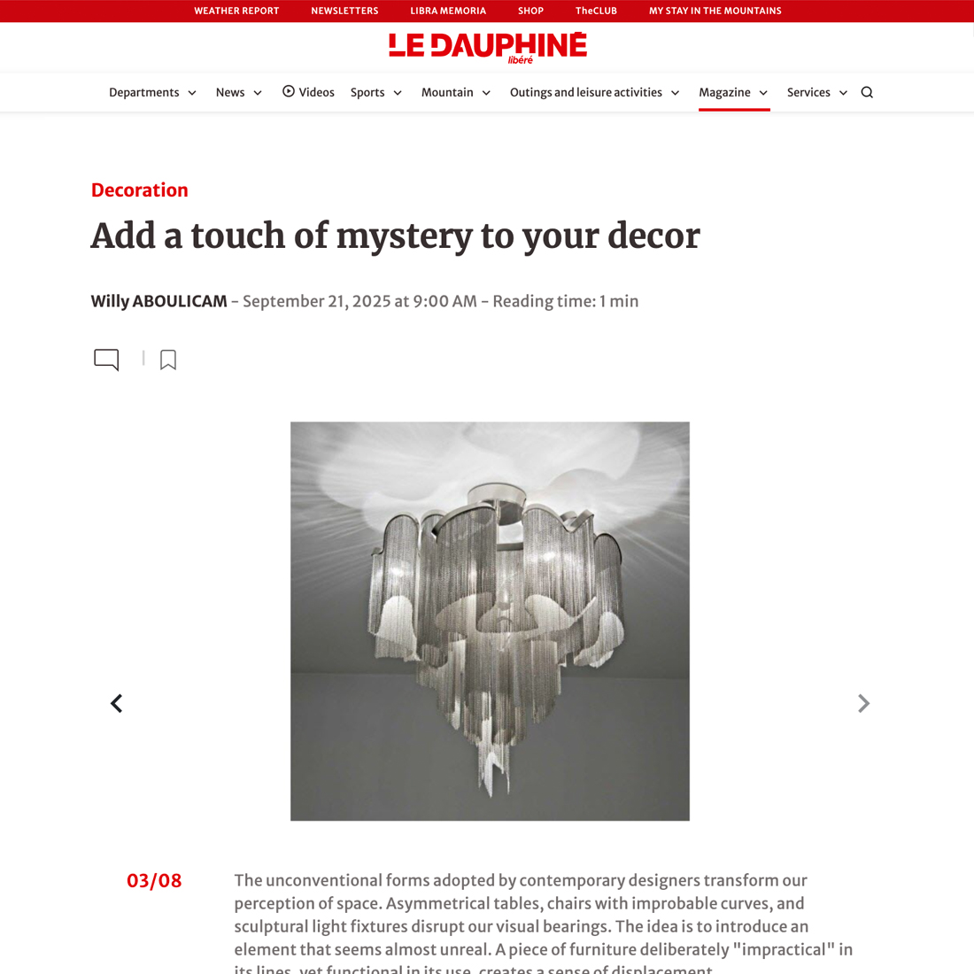 A modern chandelier with cascading metallic chains hangs from the ceiling, illuminated softly. The image appears on a webpage with the headline "Add a touch of mystery to your décor" by Le Dauphiné.