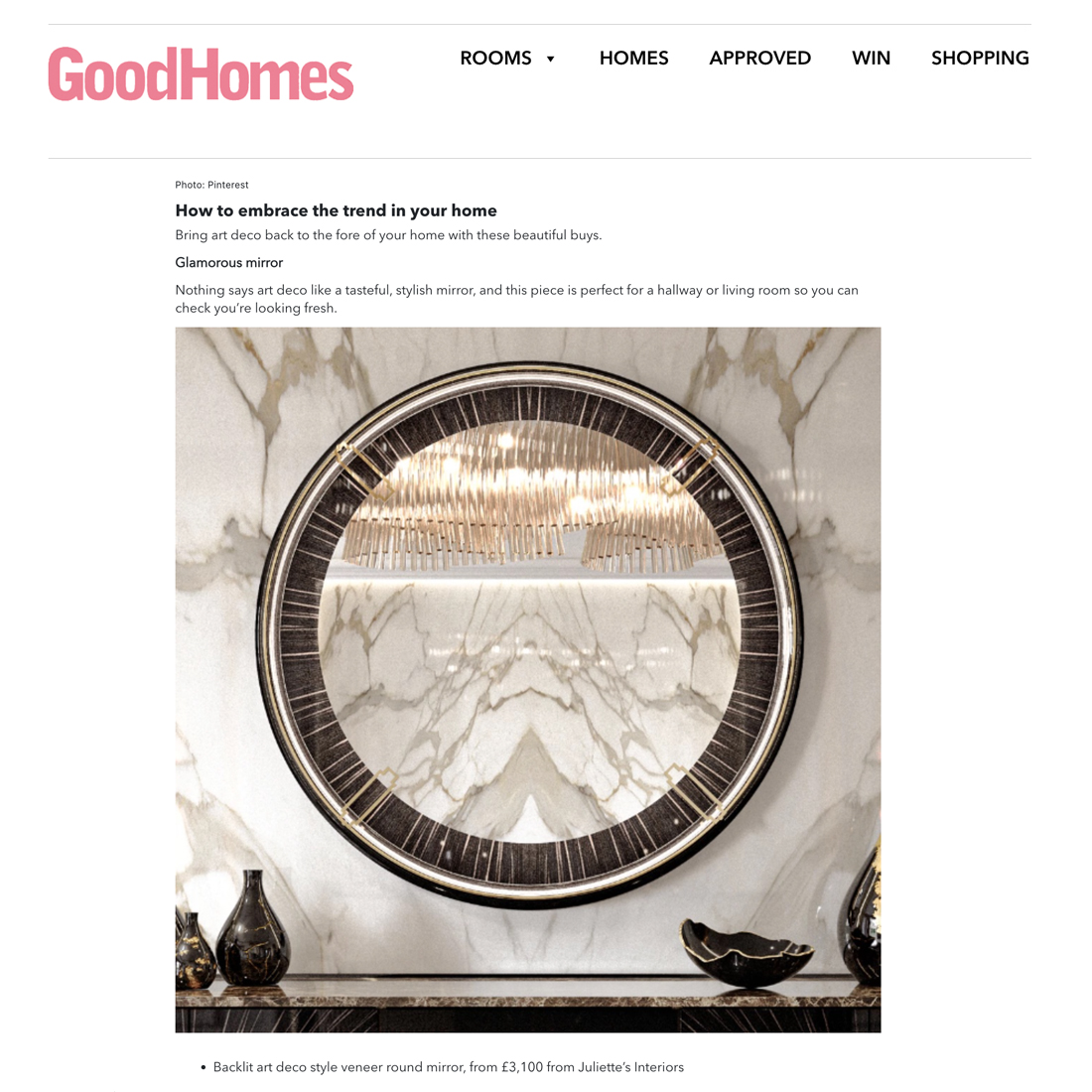 A stylish round mirror with an art deco design, featuring a marble wall backdrop and a decorative light fitting above, embodies the modern interior style Pinterest reveals in its trend predictions for 2026.