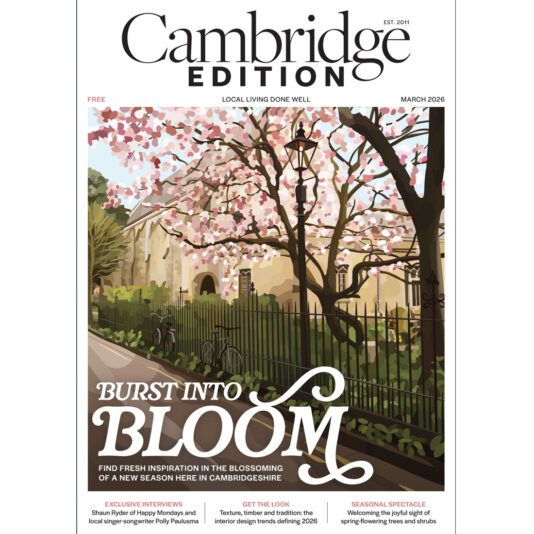 Cover of Cambridge Edition magazine featuring cherry blossom trees in full bloom over a black iron fence, with “Burst Into Bloom” written in large text. The issue is dated March 2026.