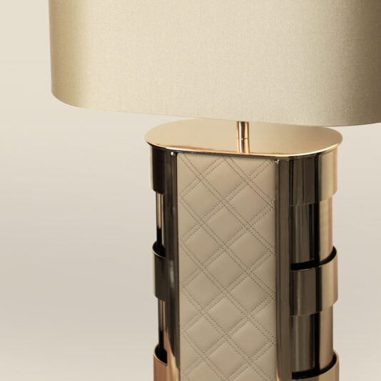 Luxury Hand-Stitched Leather Table Lamp Close-up of the Luxury Quilted Faux Leather Table Lamp, featuring quilted faux leather detailing, a beige fabric lampshade, and a metallic base with a shiny finish.