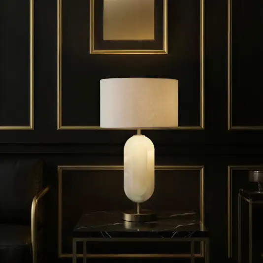 Elegant table lamp with a curved opal glass shade set on a modern, structured step-style base.