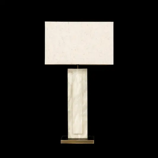 The Opal Rectangle Step Table Lamp showcases a white fabric shade, marble-effect base, and gold metal plinth for an elegant look.