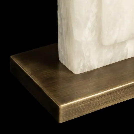 Close-up of the Opal Rectangle Step Table Lamp, showcasing a white textured stone slab on a rectangular antique brass base against a black background.