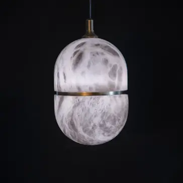 Luxury Banded Stone Ellipse Light The Banded Elipse Pendant Light – Antique Brass features a marble-inspired spherical shade divided by an antique brass band, casting a soft glow and adding modern elegance to any space.