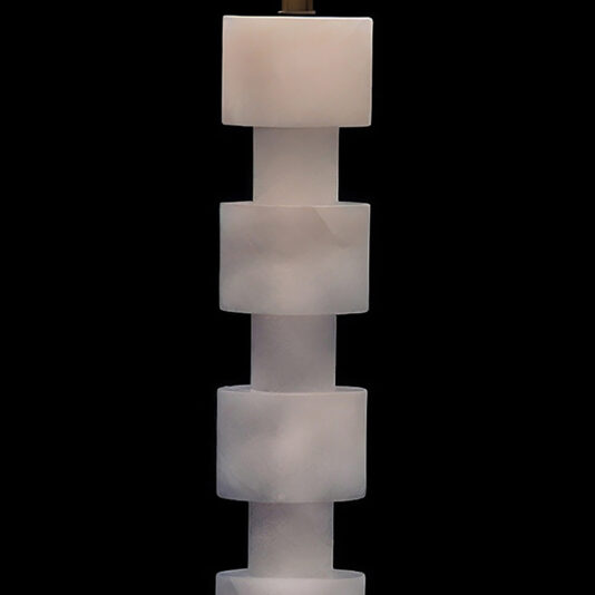 Five frosted, translucent white cubes are stacked vertically to create a striking silhouette against a black background, highlighting the modern elegance of the Round Stacked Table Lamp.