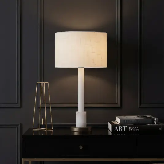 A modern glass accent lamp styled on a contemporary side table in a living space.