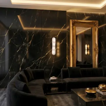 Modern lozenge shape Wall Light A luxurious living room with glossy black marble walls, a large ornate gold-framed mirror, a dark velvet corner sofa, and modern lighting, creating an elegant and sophisticated atmosphere.