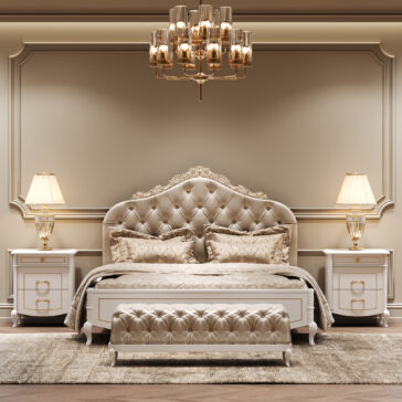 Button Upholstered Bed With Ornate Carvings A luxurious bedroom showcases the Button Upholstered Bed With Ornate Carvings, a matching bench, elegant bedding, two bedside tables with gold lamps, a plush rug, and a gold chandelier in soft beige and gold tones.