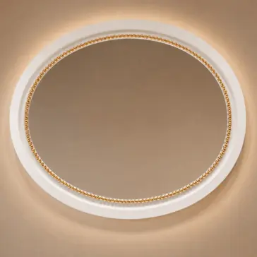 Classic Style Oval Beaded Mirror An oval mirror with a white and gold beaded frame is mounted on a beige wall, illuminated softly from behind, creating a warm and elegant appearance.