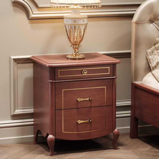 Classic Style Cherrywood Bedside Cabinet The Classic Style Briarwood Bedside Cabinet with gold accents and ornate handles on two drawers stands beside a tufted headboard bed, topped with a decorative gold and white lamp in an elegant room.