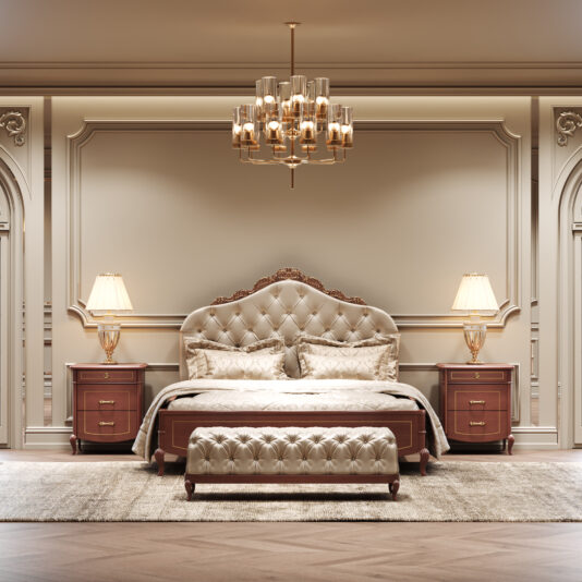Classic Style Cherrywood Bedside Cabinet A luxurious bedroom with a tufted headboard, matching ottoman, elegant bedlinen, and a large carpet features two Classic Style Cherrywood Bedside Cabinets beside the bed, both topped with lamps and enhanced by a chandelier in an ornate classic setting.