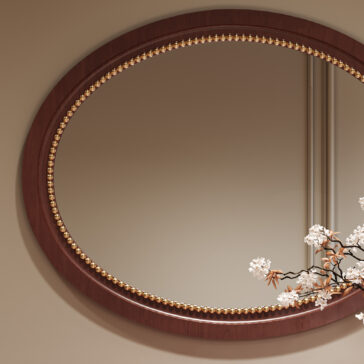 Classic Style Cherrywood Oval Beaded Mirror The Classic Style Cherrywood Oval Beaded Mirror has a dark wood frame with gold bead accents. In the mirror’s reflection, a branch of small white flowers appears in the lower right corner.