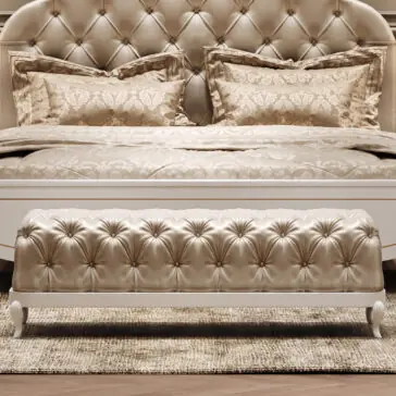 Elegant Button Upholstered Bench The Elegant Button Upholstered Bench rests at the foot of a tufted cream bed with ornate pillows and bedding, all atop a textured rug, creating a luxurious and sophisticated bedroom atmosphere.