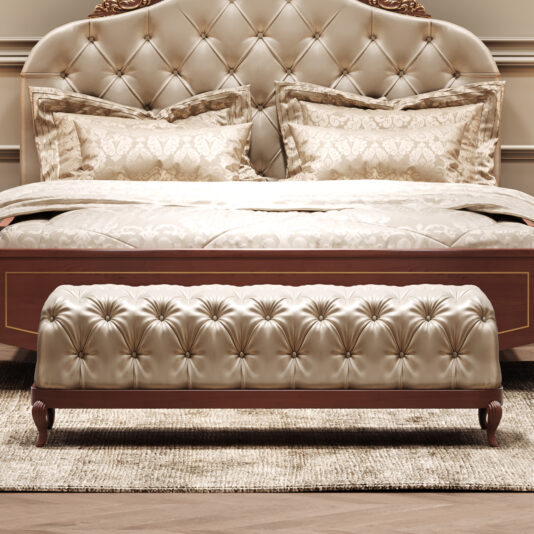 Elegant Cherrywood Button Upholstered Bench Elegant bedroom with a large tufted satin headboard, matching pillows and bedspread, and the Elegant Button Upholstered Bench (Copy) at the foot of the bed on a beige rug. The furniture has wood accents.