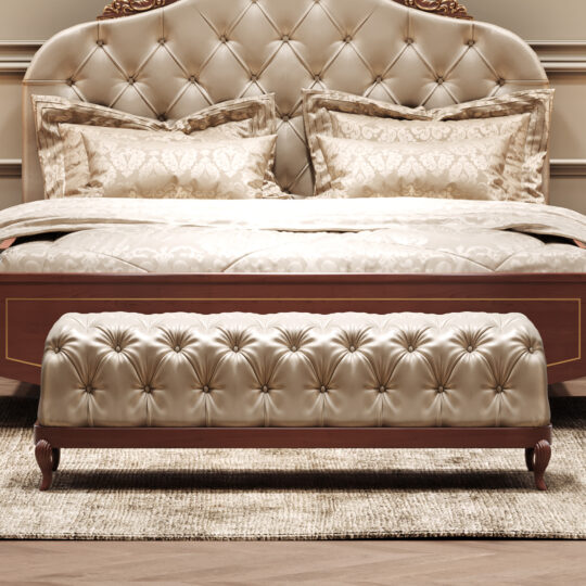Elegant bedroom with a large tufted satin headboard, matching pillows and bedspread, and the Elegant Button Upholstered Bench (Copy) at the foot of the bed on a beige rug. The furniture has wood accents.