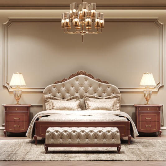 Ornate Cherrywood Button Upholstered Bed Elegant bedroom with an Ornate Cherrywood Button Upholstered Bed and bench, wooden bedside tables topped with gold lamps, a gold chandelier overhead, beige walls with decorative moulding, and a neutral rug on the floor.