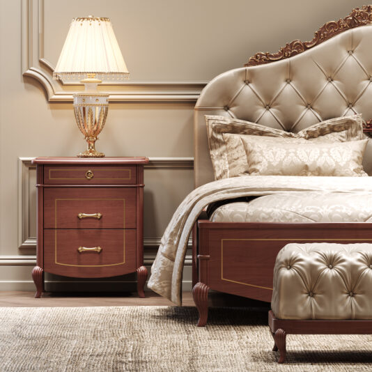 Ornate Cherrywood Button Upholstered Bed Elegant bedroom with the Ornate Cherrywood Button Upholstered Bed, coordinating bedding, and a wooden bedside table topped by a gold-accented lamp. Classic wall moulding and a textured beige carpet lend timeless charm to the space.