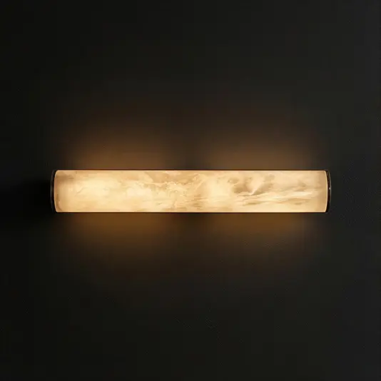 Marbled Tube Wall Light A cylindrical wall sconce with a glowing, marbled glass shade emits warm, soft light against a dark textured wall.