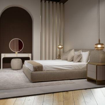 Modern bedroom featuring a beige upholstered bed, cream bedding, two pendant lights, a round mirror on the Contemporary Lacquered Dressing Table, a pouffe, bedside table, soft neutral walls, and light wood flooring.