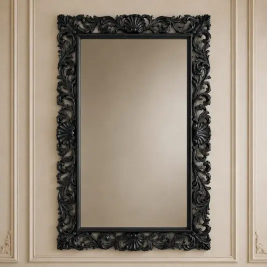 Ornate Black Baroque Wall Mirror A large rectangular mirror with an ornate, black, carved frame hangs on a beige wall with decorative moulding.