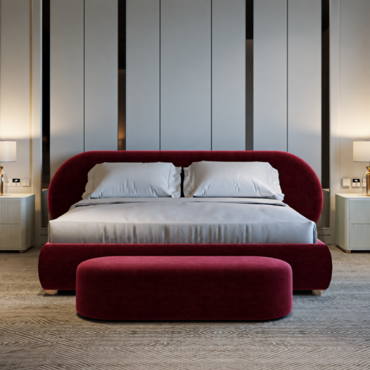 Curved contemporary burgundy velvet bed with pale bedding and matching oval bench, viewed from the front.