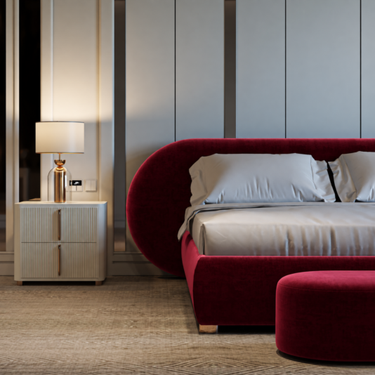 Curved Contemporary Burgundy Velvet Bed Close view of the rounded headboard and padded base beside a white bedside cabinet.