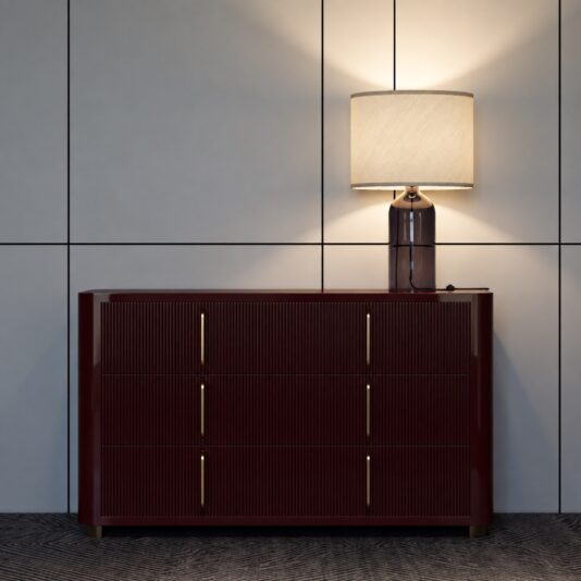 Burgundy Gloss Ribbed Chest of Drawers Burgundy ribbed chest of drawers with a gloss finish beneath a table lamp