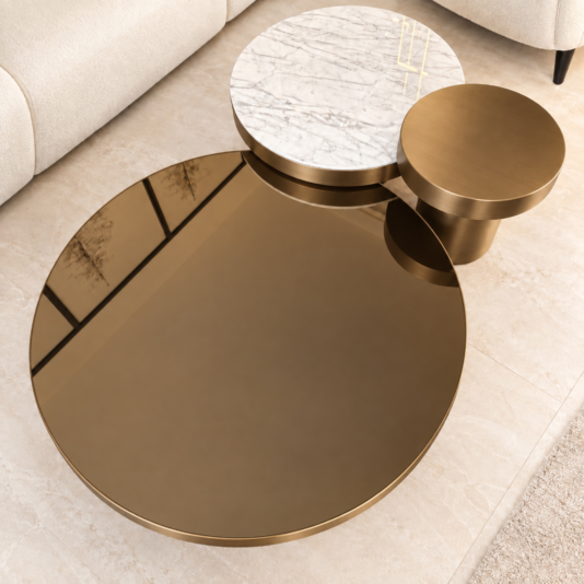 Overhead view of round coffee table set in brushed bronze with three coordinated tops